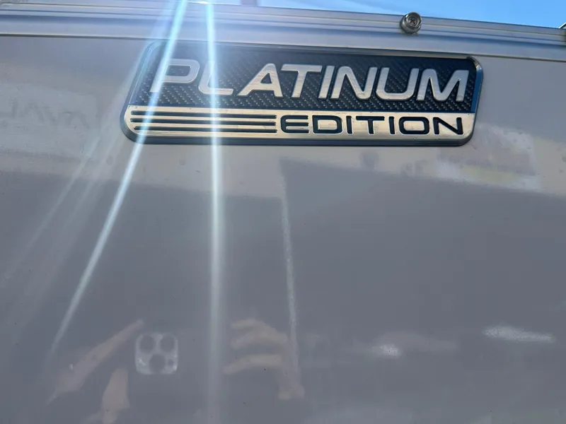 Slide: The Image of 2025 Avalon Catalina Cruise Funship 27' Platinum Edition badge with sunlight reflection. - 7