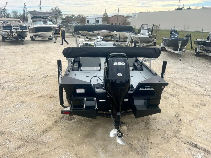 Slide: The Image of 2024 SeaArk BIG EASY 24 boat with 250 HP engine, parked in a marina. - 6