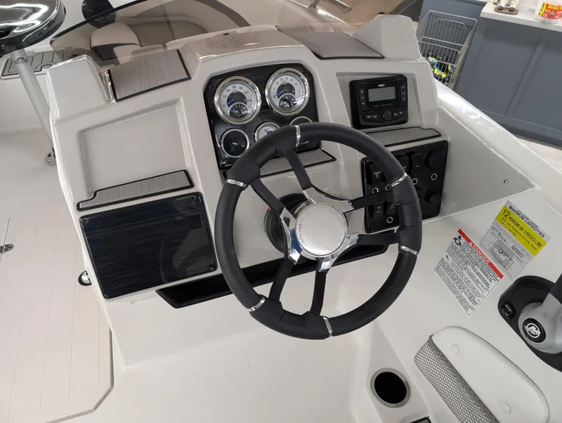 Slide: The Image of 2025 Starcraft SVX 191 OB boat dashboard with steering wheel and gauges. - 10