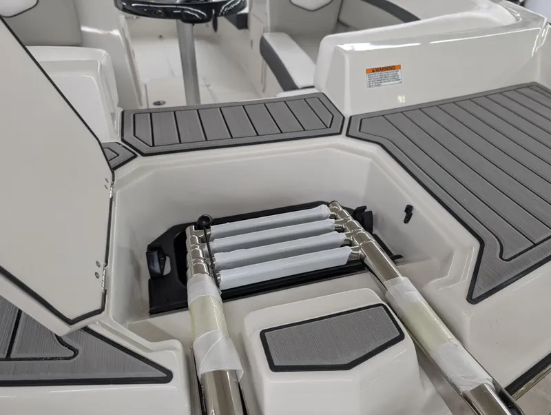 Slide: The Image of 2025 Starcraft SVX 191 OB boat interior with foldable ladder and seating area. - 13