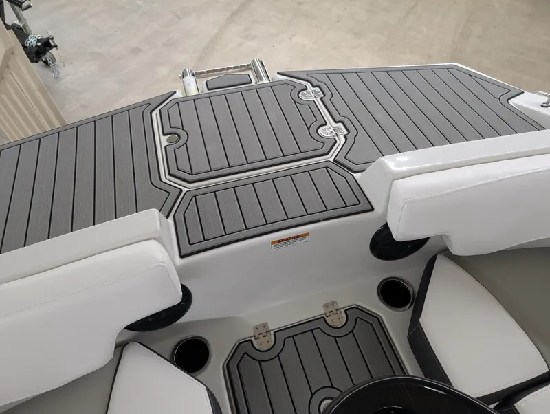 Slide: The Image of 2025 Starcraft SVX 191 OB boat interior with sleek gray decking and white seating. - 4