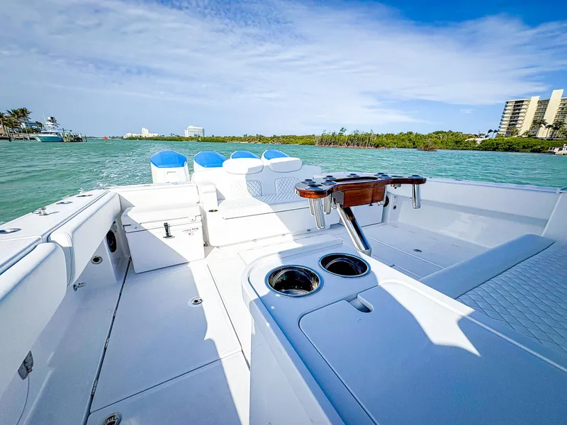 Slide: The Image of 2025 HCB 48 Campeon boat on water, featuring spacious deck and seating. - 10
