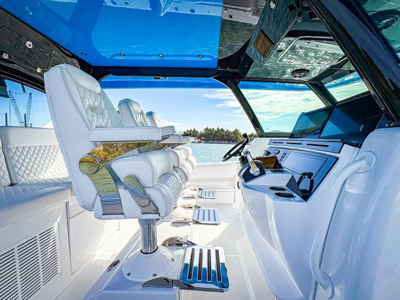Slide: The Image of Luxurious interior of 2025 HCB 48 Campeon boat with plush seating and modern dashboard. - 14