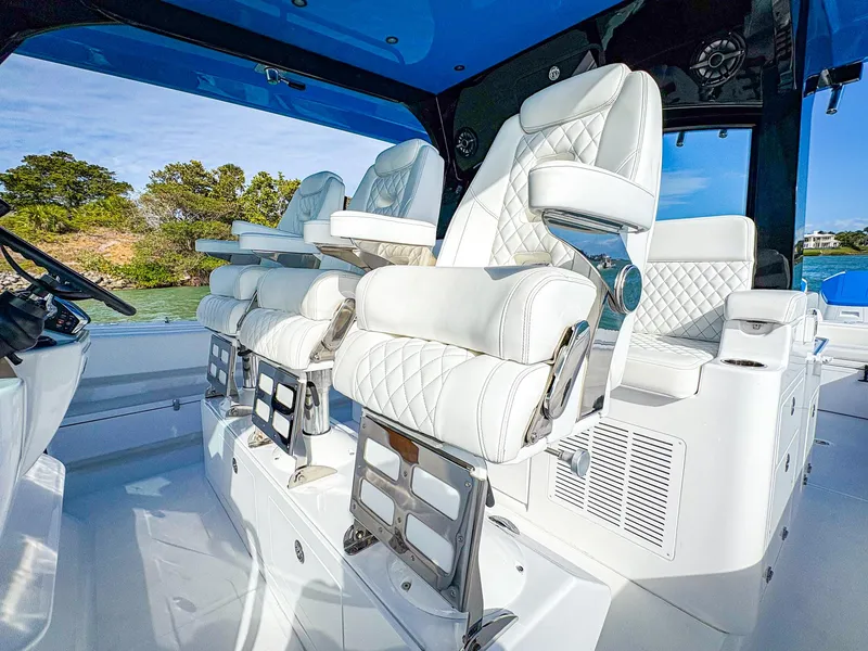 Slide: The Image of Luxurious seating on 2025 HCB 48 Campeon boat with white quilted upholstery. - 17