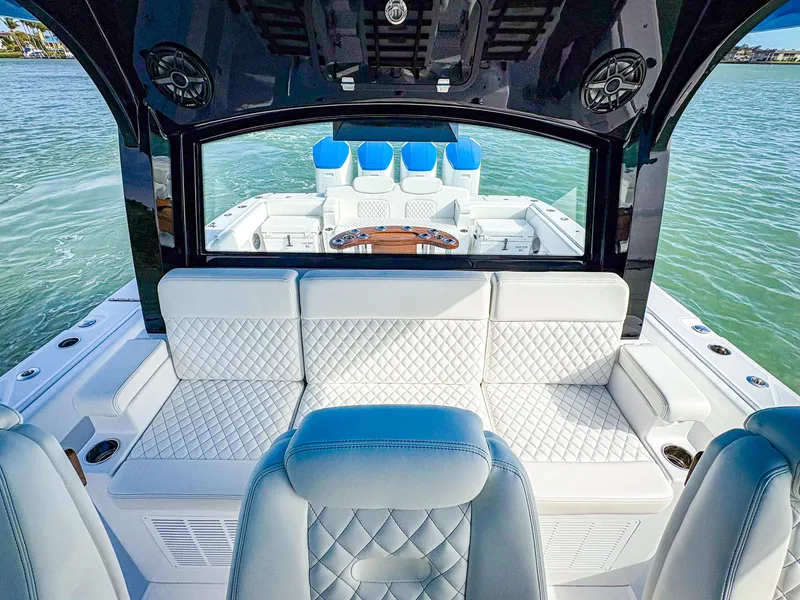 Slide: The Image of Luxurious 2025 HCB 48 Campeon boat interior with plush seating on the water. - 23