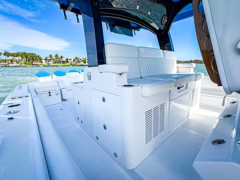 Slide: The Image of Luxurious 2025 HCB 48 Campeon boat interior with white seating and ocean view. - 24