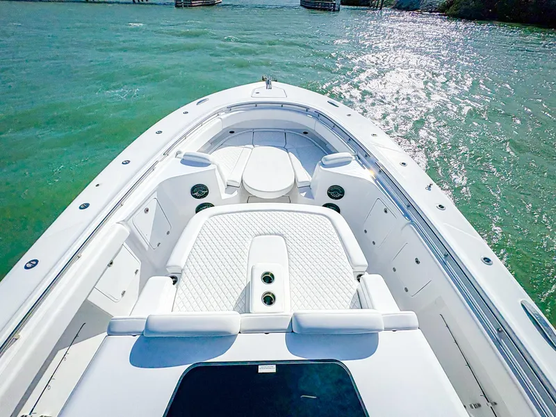 Slide: The Image of 2025 HCB 48 Campeon boat on clear turquoise water, showcasing luxurious deck design. - 27