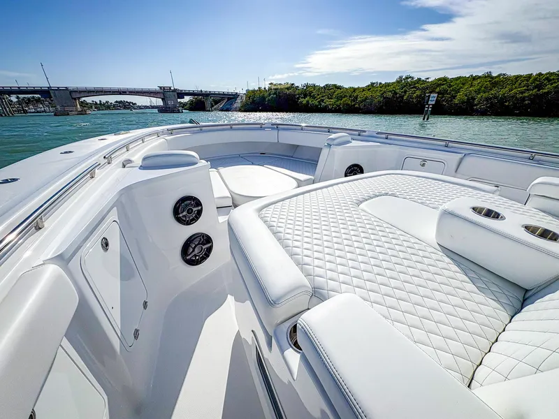 Slide: The Image of 2025 HCB 48 Campeon luxury boat interior with quilted seating, on a sunny day. - 28