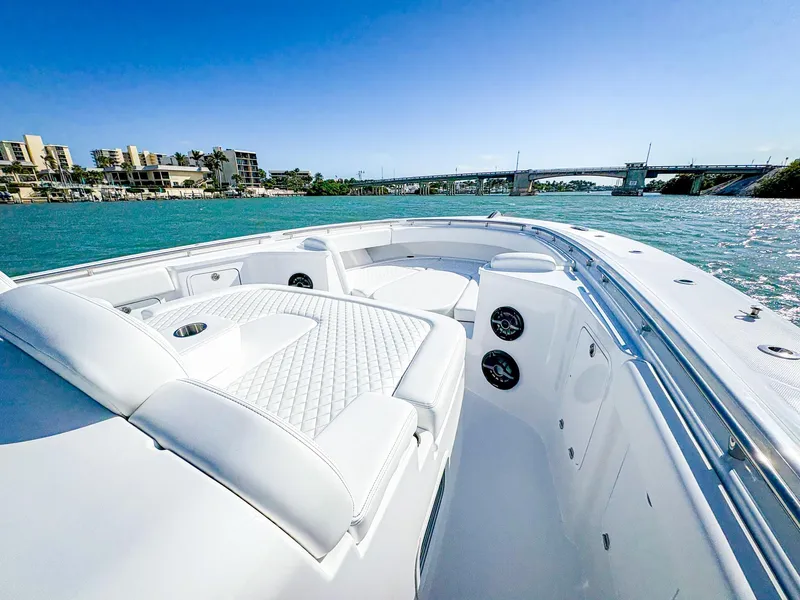 Slide: The Image of 2025 HCB 48 Campeon luxury boat cruising on clear blue waters. - 29