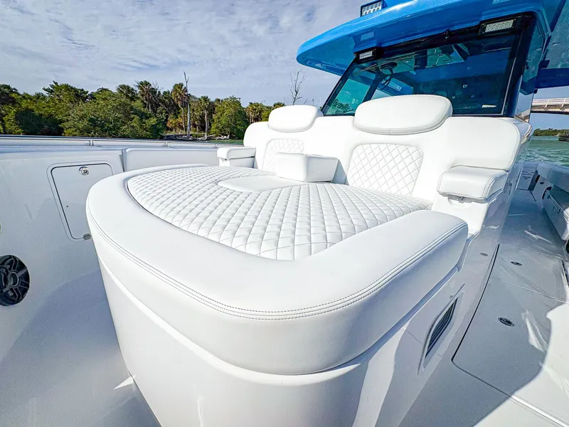 Slide: The Image of Luxurious seating on 2025 HCB 48 Campeon boat with quilted white upholstery. - 31