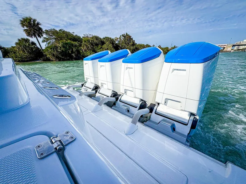 Slide: The Image of 2025 HCB 48 Campeon boat with four powerful outboard engines on a sunny day. - 34