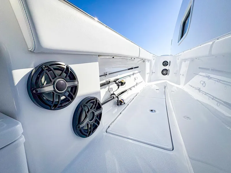 Slide: The Image of 2025 HCB 48 Campeon boat interior with speakers and fishing rod storage. - 35