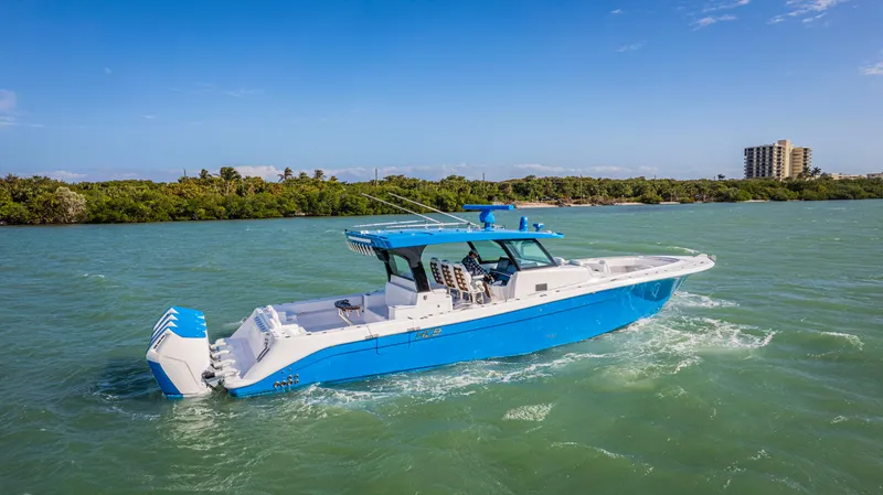 Slide: The Image of 2025 HCB 48 Campeon boat cruising on a sunny day in blue waters. - 4