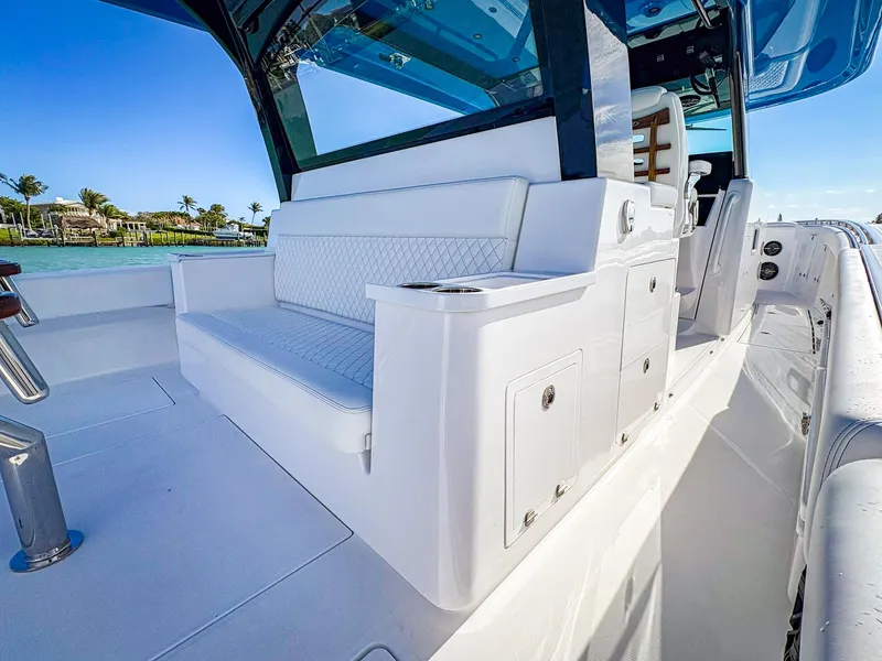 Slide: The Image of 2025 HCB 48 Campeon luxury boat interior with white seating and sleek design. - 7