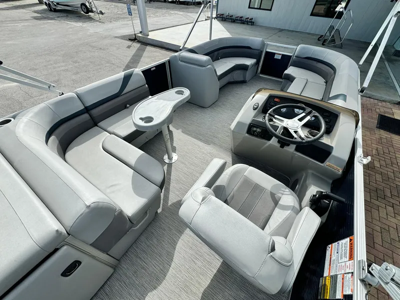 Slide: The Image of 2020 Bennington 22SSXAPG pontoon boat interior with gray seating and steering console. - 10