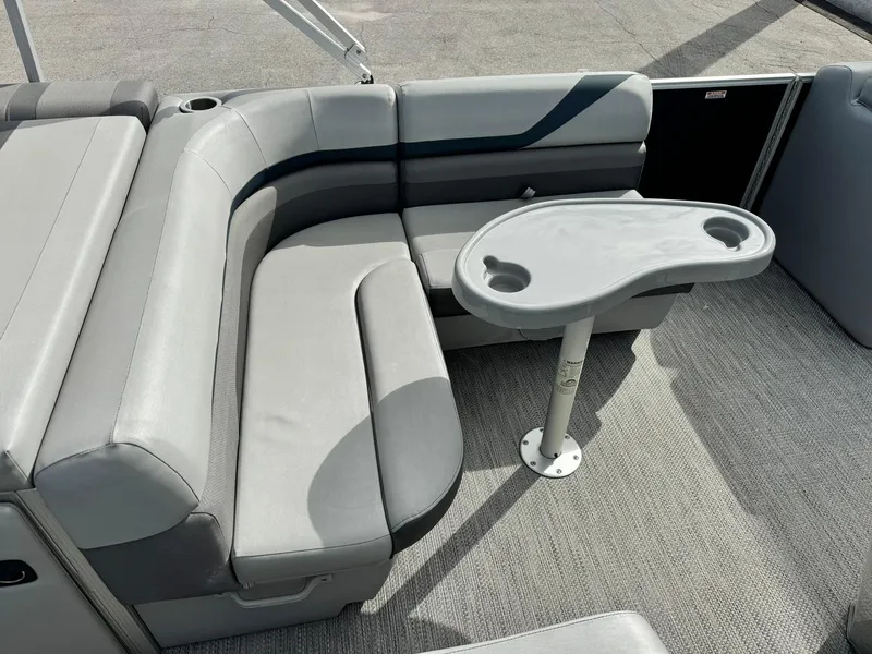 Slide: The Image of 2020 Bennington 22SSXAPG pontoon boat interior with gray seating and table. - 11