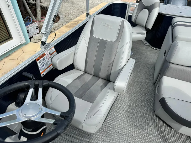 Slide: The Image of 2020 Bennington 22SSXAPG boat interior with steering wheel and captain's chair. - 14