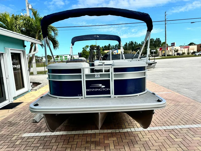 Slide: The Image of 2020 Bennington 22SSXAPG pontoon boat parked on brick pavement. - 2