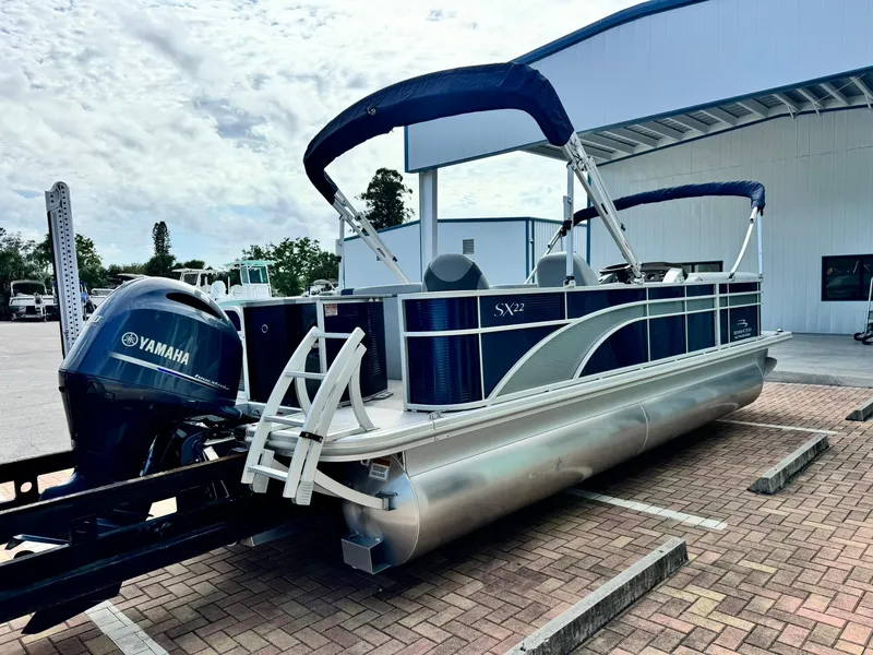 Slide: The Image of 2020 Bennington 22SSXAPG pontoon boat with Yamaha engine, parked outdoors. - 4