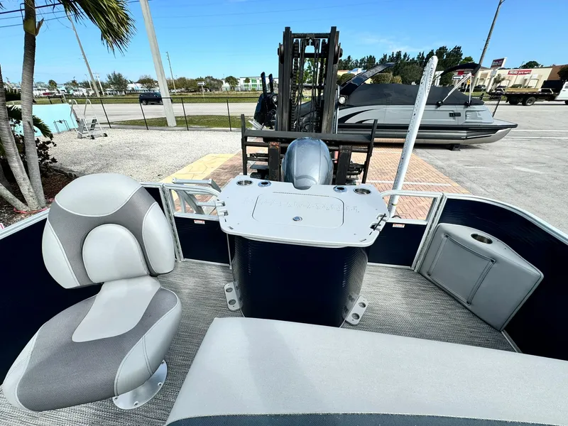 Slide: The Image of 2020 Bennington 22SSXAPG pontoon boat interior with seating and helm station. - 7