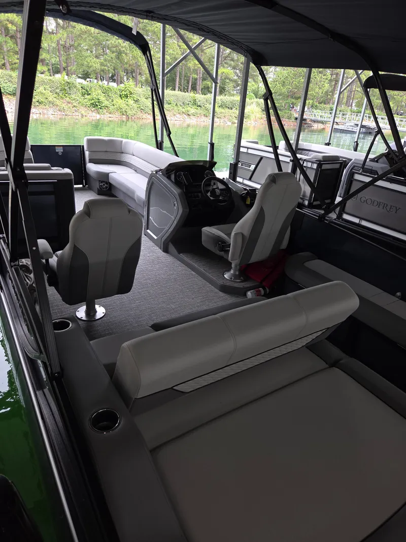 Slide: The Image of 2025 Godfrey Monaco 255 SFL pontoon boat interior with plush seating and modern helm. - 13