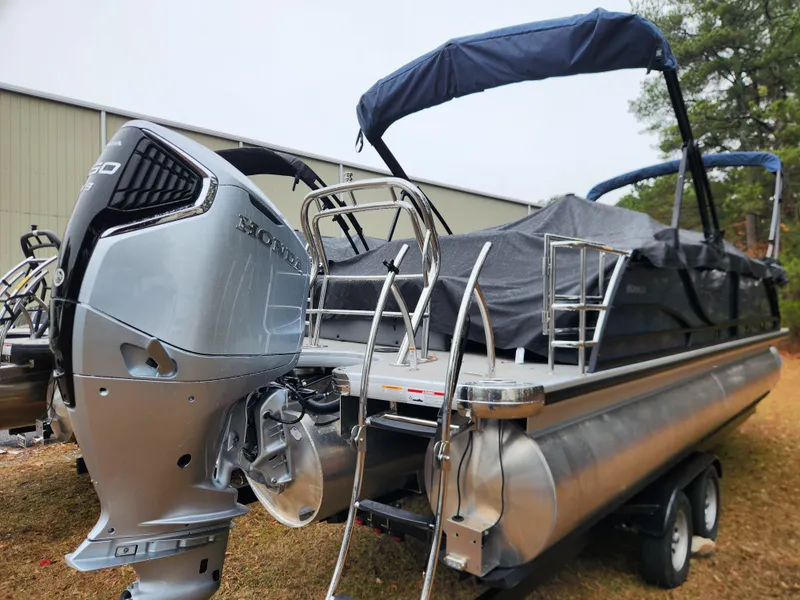 Slide: The Image of 2025 Godfrey Monaco 255 SFL pontoon boat with Honda outboard motor, on trailer. - 4