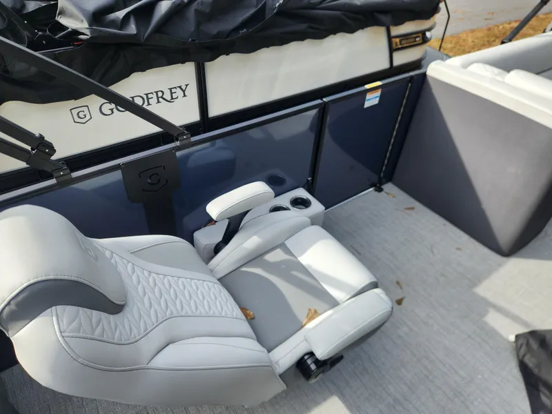 Slide: The Image of 2025 Godfrey Monaco 255 SFL boat interior with gray seating and cup holders. - 5