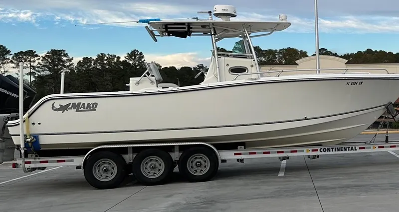 Slide: The Image of 2020 Mako 284 CC boat on trailer, parked outdoors. - 1