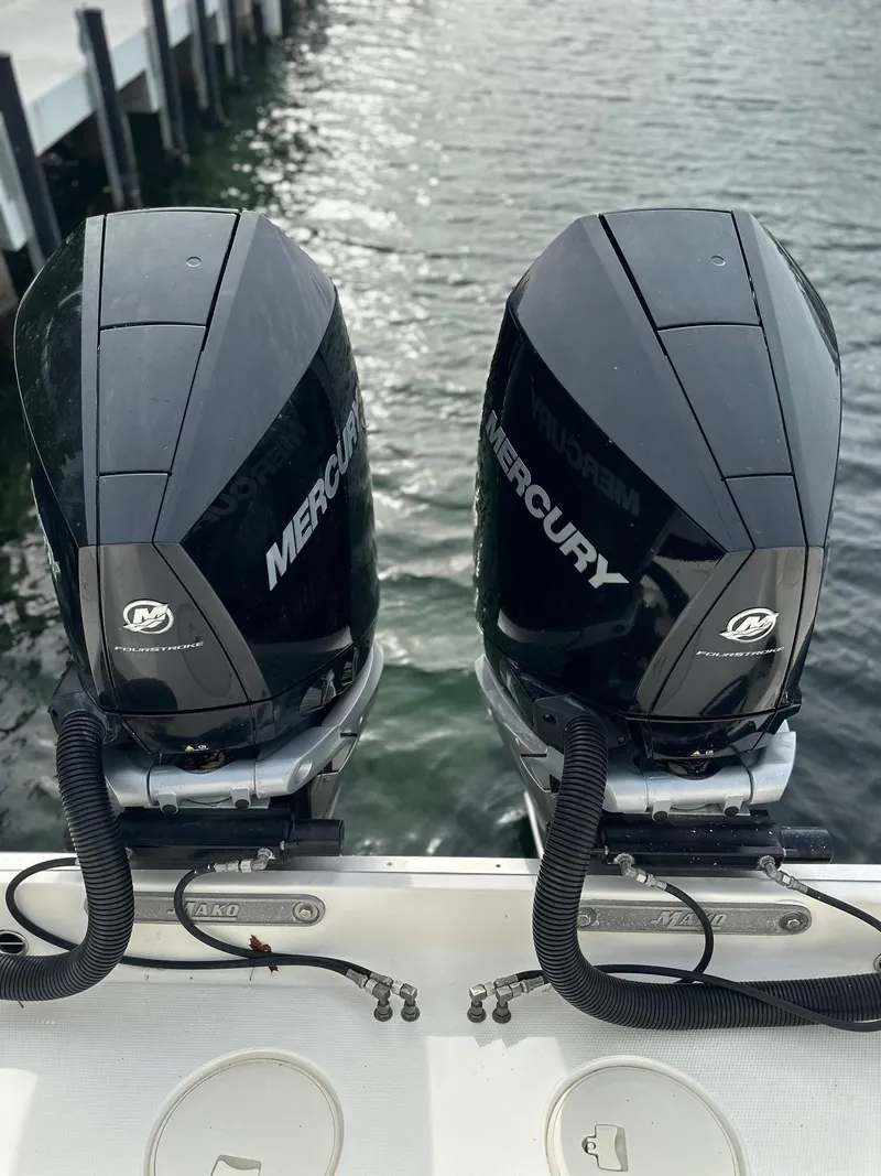 Slide: The Image of 2020 Mako 284 CC boat with dual Mercury outboard engines on water. - 11