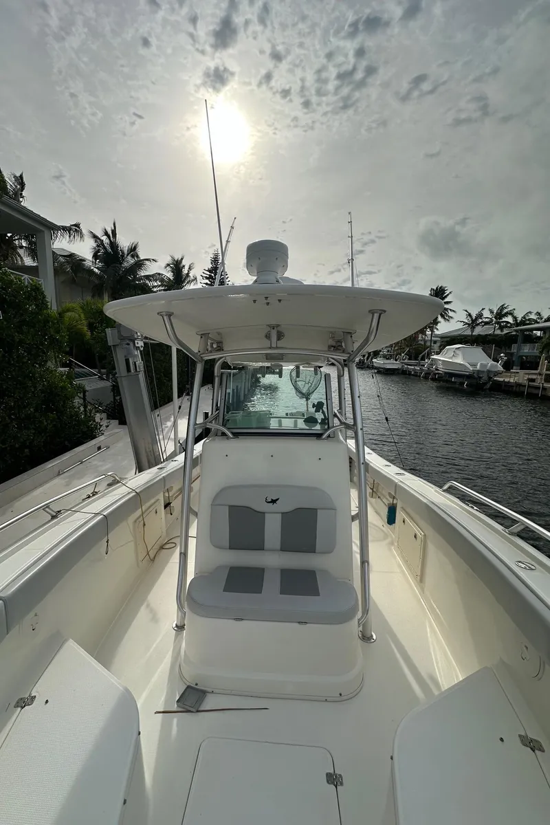 Slide: The Image of 2020 Mako 284 CC boat on a sunny day by the water. - 3