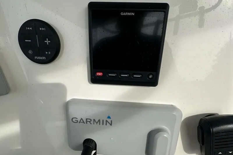 Slide: The Image of Garmin display and controls on 2020 Mako 284 CC boat dashboard. - 8