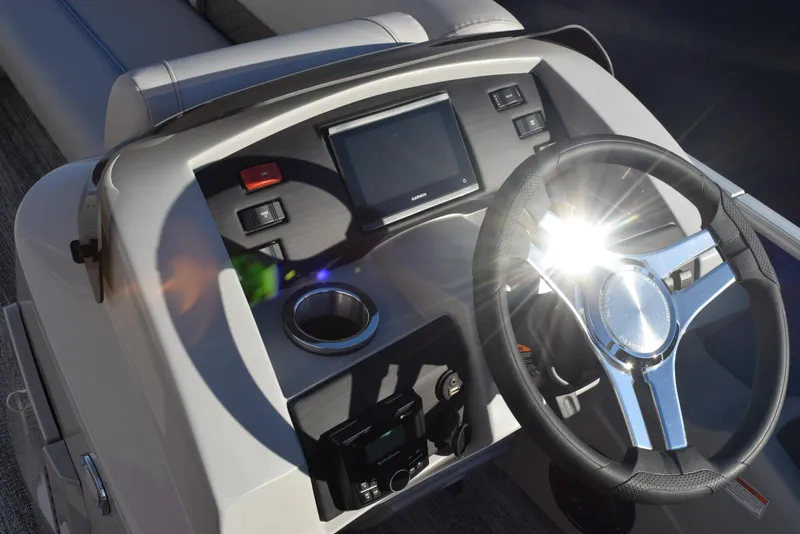 Slide: The Image of 2025 Bennington SX 24 Quad Bench dashboard with steering wheel and control panel. - 10