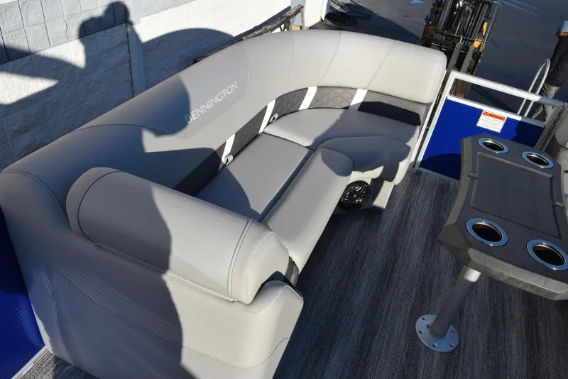 Slide: The Image of 2025 Bennington SX 24 Quad Bench with gray seating and cup holders on a boat deck. - 12