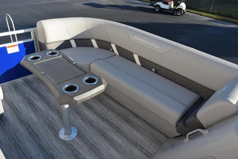 Slide: The Image of 2025 Bennington SX 24 Quad Bench with cup holders and plush seating on a boat deck. - 13