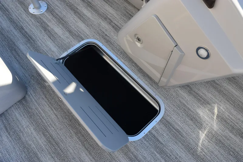 Slide: The Image of Bennington SX 24 Quad Bench 2025 storage compartment on textured flooring. - 15