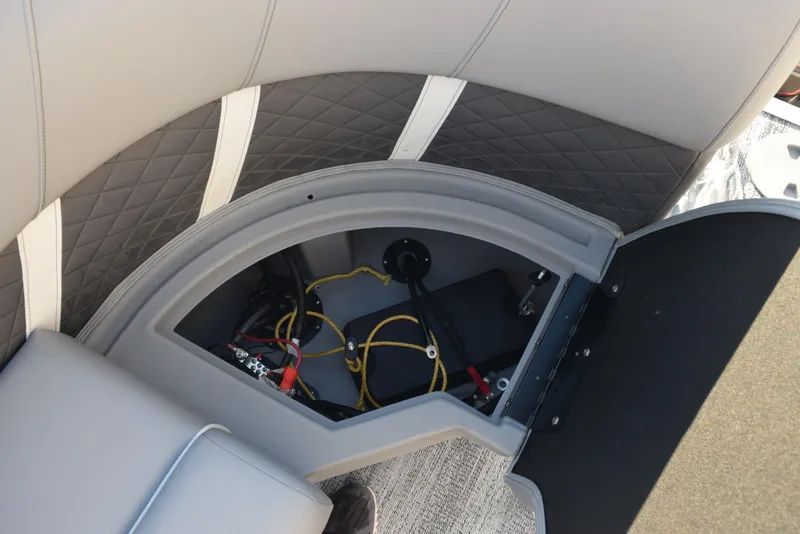 Slide: The Image of Bennington SX 24 Quad Bench 2025 storage compartment with wiring and upholstery details. - 16