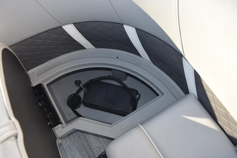 Slide: The Image of 2025 Bennington SX 24 Quad Bench interior with quilted upholstery and storage compartment. - 17