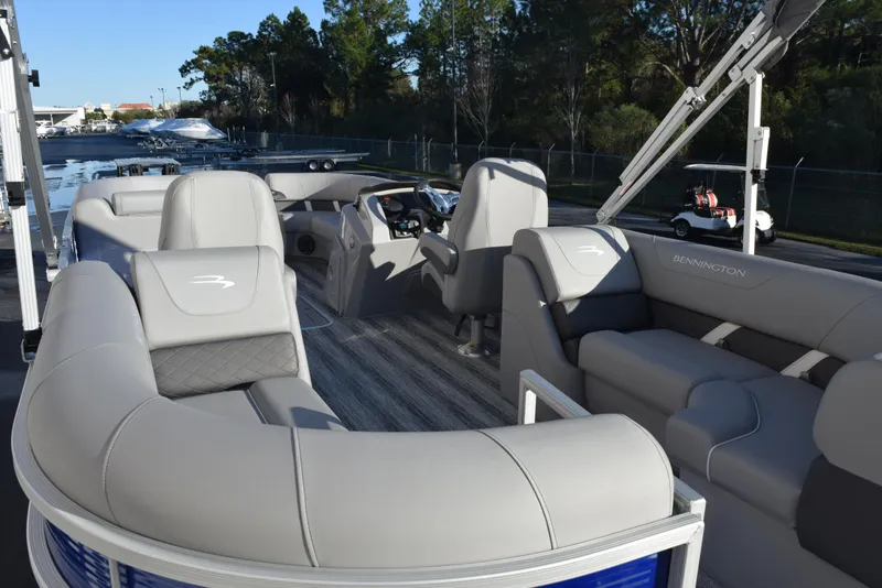 Slide: The Image of 2025 Bennington SX 24 Quad Bench pontoon boat with luxurious seating and modern design. - 7