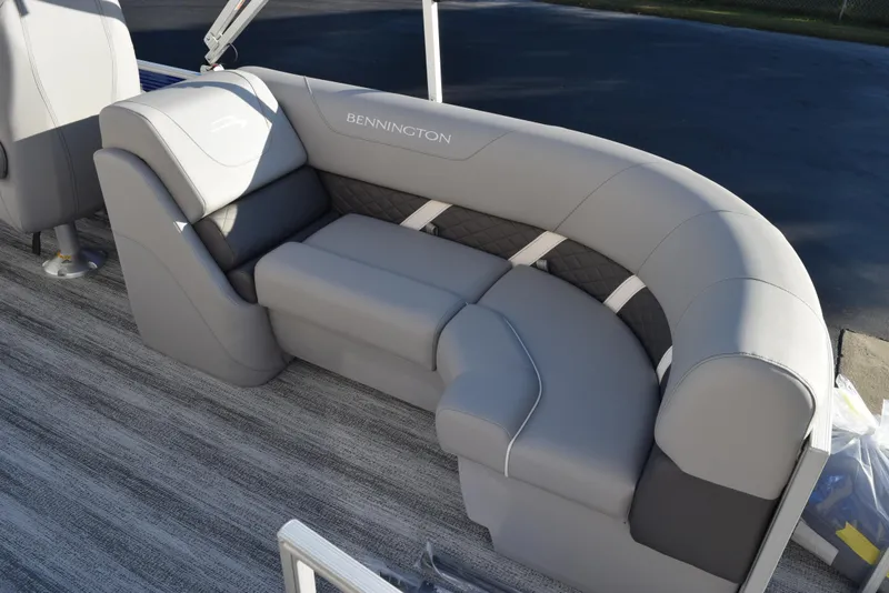 Slide: The Image of 2025 Bennington SX 24 Quad Bench with luxurious gray seating on a boat. - 8