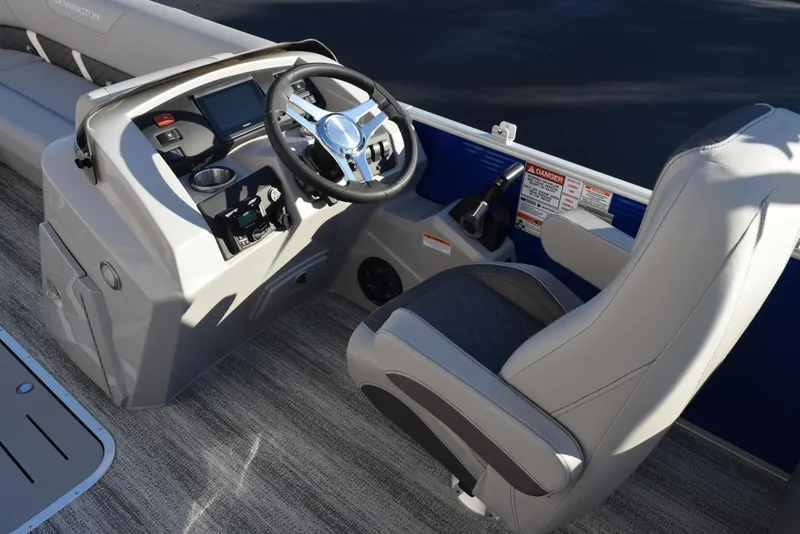 Slide: The Image of 2025 Bennington SX 24 Quad Bench boat interior with steering wheel and seating. - 9