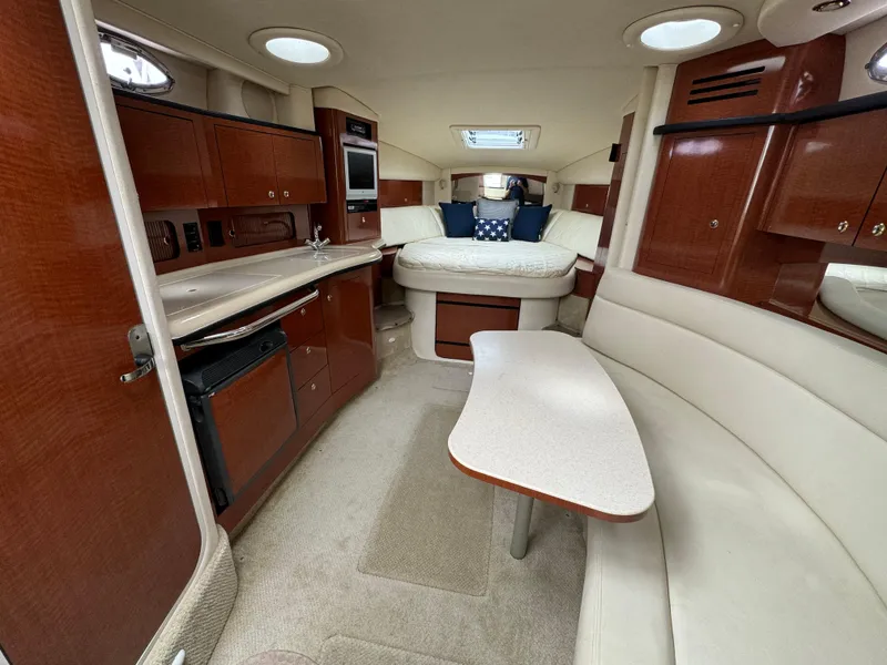 Slide: The Image of Luxurious interior of 2004 Sea Ray 320 Sundancer yacht with cozy seating and modern amenities. - 14