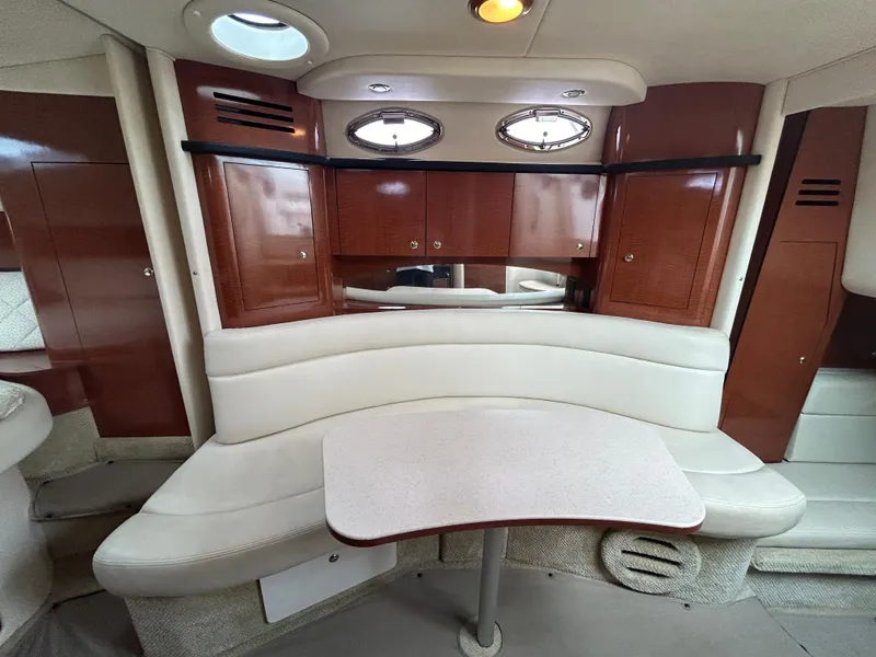 Slide: The Image of Luxurious 2004 Sea Ray 320 Sundancer cabin interior with elegant seating and wooden cabinetry. - 16