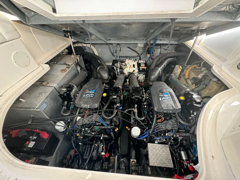 Slide: The Image of Engine compartment of 2004 Sea Ray 320 Sundancer boat, showcasing dual engines and components. - 19