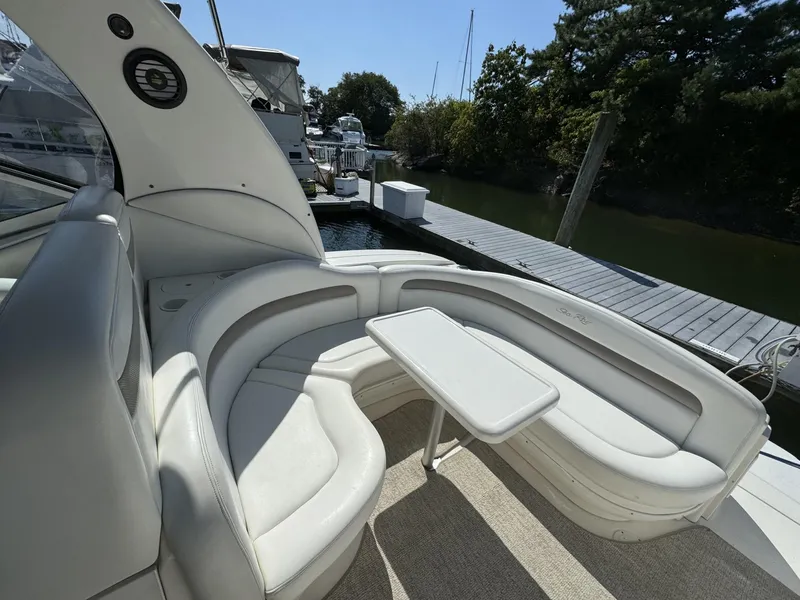 Slide: The Image of Luxurious 2004 Sea Ray 320 Sundancer boat interior with white seating and table. - 5