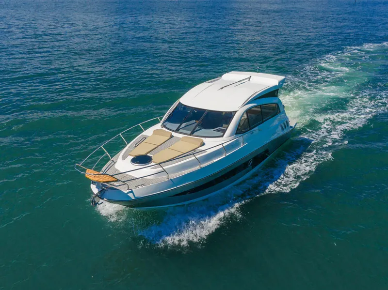 Slide: The Image of 2025 Hanover 375 Outboard cruising on open water. - 5