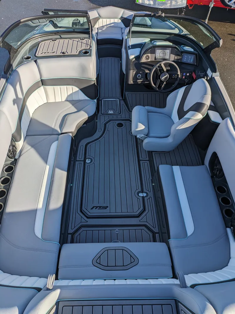 Slide: The Image of 2025 MB B52-21 Alpha boat interior with sleek gray seating and modern dashboard. - 14