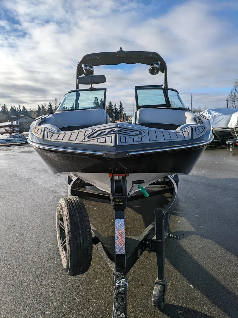 Slide: The Image of 2025 MB B52-21 Alpha boat on trailer, parked outdoors under cloudy sky. - 20