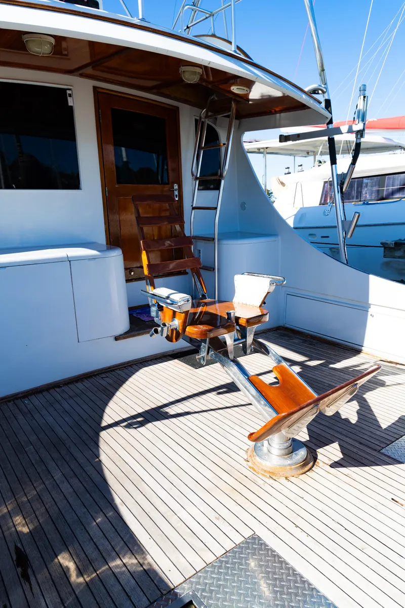 Slide: The Image of 1987 Buddy Davis 61 Convertible yacht deck with fishing chair and rod holders. - 11