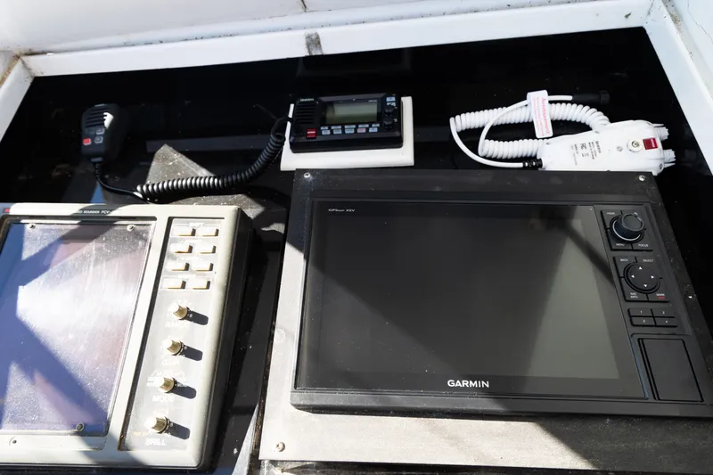 Slide: The Image of Control panel of a 1987 Buddy Davis 61 Convertible with Garmin navigation equipment. - 14