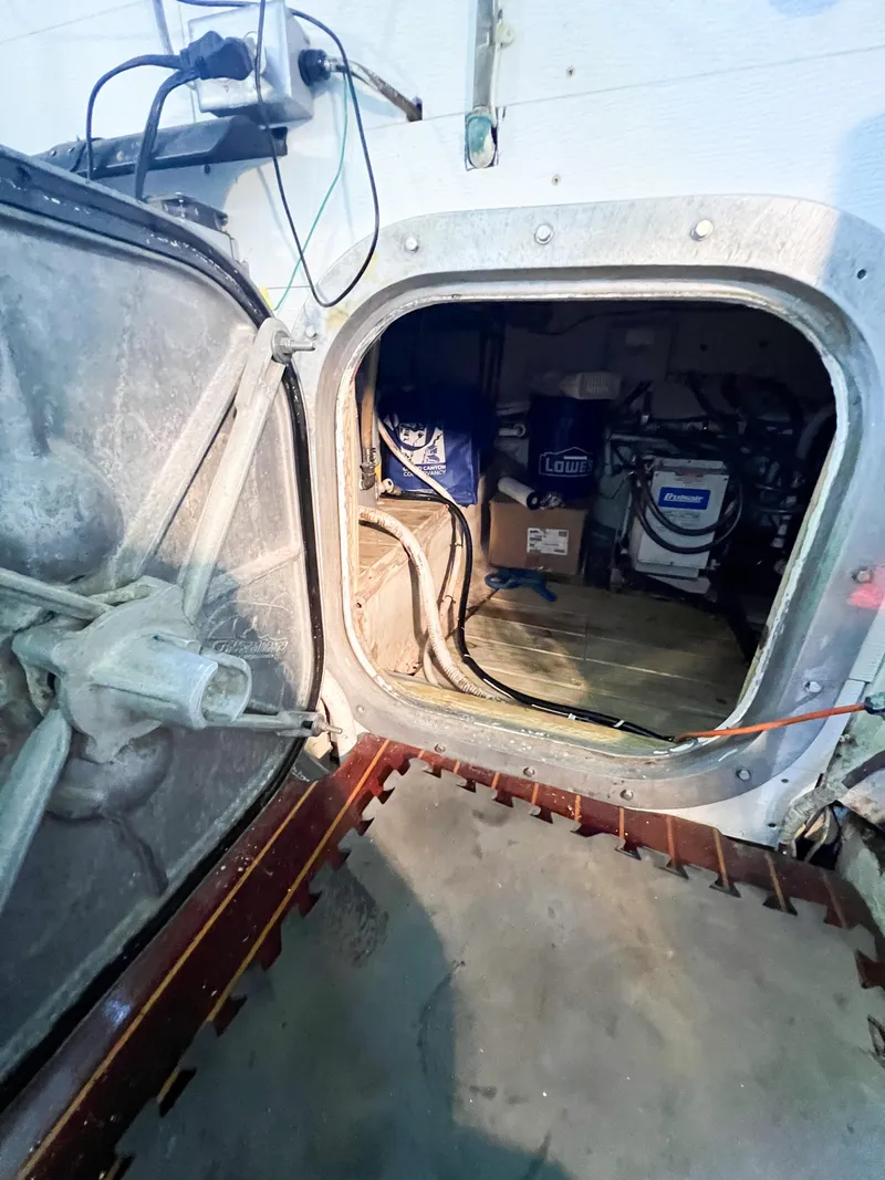 Slide: The Image of Engine room access hatch on a 1987 Buddy Davis 61 Convertible boat. - 26